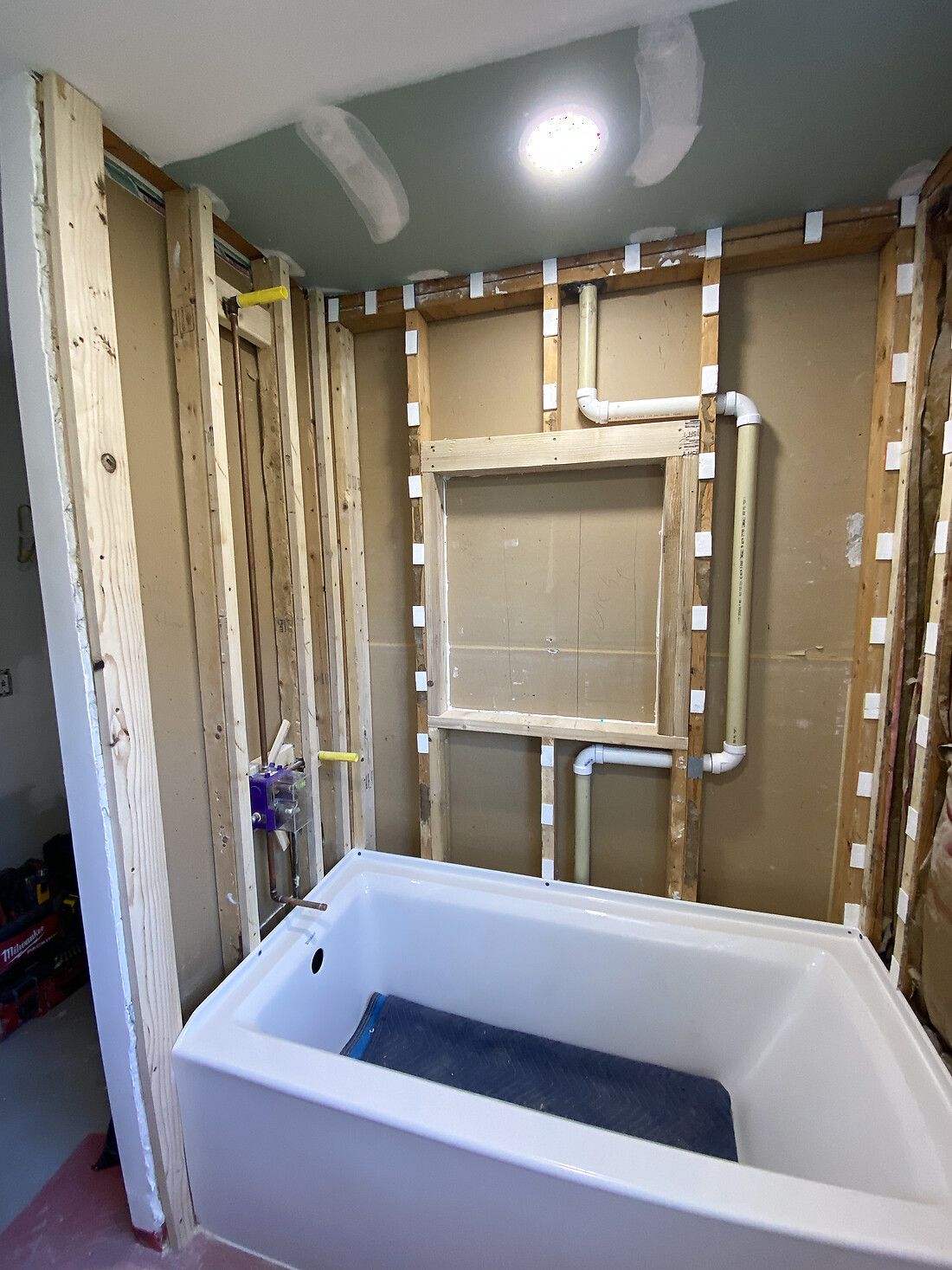 Bathtub alcove as bare framing with the plumbing rough-in